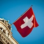 swiss flag waving on historic building